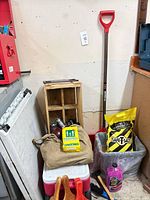 Overall lot view with cooler, crate, shovel, salt bag, accessories