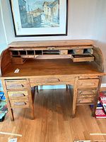 Desk open showing interior pigeonholes, drawers, oak surface