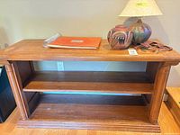 Console table front view with shelves and items on top