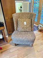 Front view of upholstered chair showing pattern and cushion