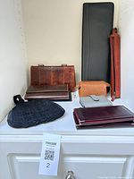 Shelf with wallets, coin purses, pencil case, brush holder