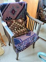 Front view of chair with throw and pillow