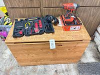 Full view of pine chest with tool kit and impact driver on top