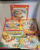 Five Magic School Bus books laid out showing four full covers and part of a fifth