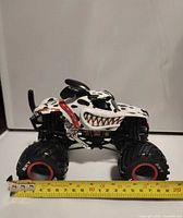 Front and side view with measuring tape showing length