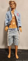 Full view of Ken doll wearing jacket and shorts