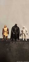 Group shot of Qui-Gon Jinn, Darth Vader, Stormtrooper figures