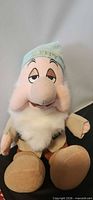 Front view of Sleepy dwarf plush showing face, cap, beard, clothing