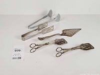 All five utensils laid out on surface