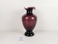 Full front view of amethyst glass vase showing overall shape