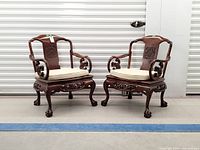 Pair of carved rosewood armchairs front view