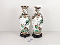 Front view of both vases showing crane motif on stands