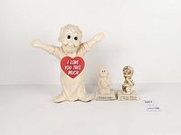 Full view of the three resin figurines side by side