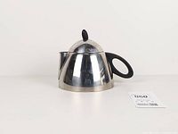 Front view showing teapot shape, handle, spout and lid