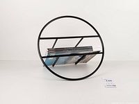 Front view showing circular frame and stored magazines