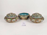 full view of two lidded jars and open bowl