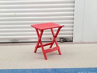 Full view of red folding side table standing