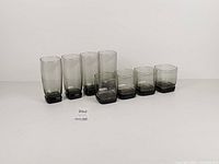 Front view of all eight glasses showing heights and color