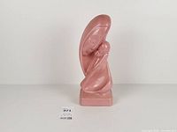 Full left-front view of statue on white backdrop with size reference tag