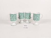 Front view of four porcelain shamrock mugs