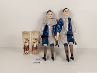 Full group shot: two harlequin dolls and two glass cylinders with Scottish soldiers