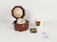 All three items: open clock, mug, patch