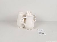 Front view showing three joined vases and handles