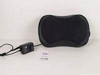 Front view of black Zyllion shiatsu massager with adapter