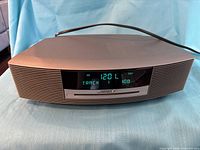 Front view showing display, slot-loading drive and speaker grille