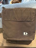 Front view of black CD carrier with logo patch visible