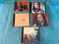 Front view of five CD jewel cases showing cover art