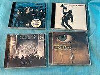 Front covers of four CDs laid out