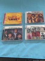 Front view of four CD albums showing cover art