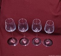 Four matching crystal stemware glasses front view
