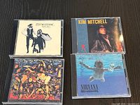 Front view of all four CD jewel cases showing cover art