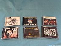 All six CDs laid out on cloth