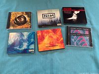 Front covers of all six Nine Inch Nails CD releases