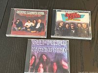 Front view of three CD jewel cases showing album covers