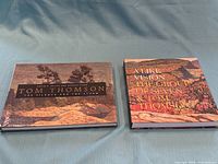 Front covers of both Tom Thomson art books displayed side by side