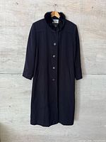 Full view of front of black wool coat on hanger