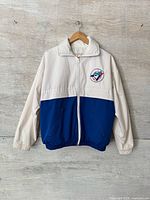 Full front view of jacket on hanger showing overall style, color block and logo