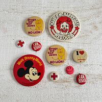 All nine buttons laid out showing fronts and relative sizes