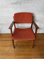 Front view of the arm chair showing seat, backrest, arms, legs