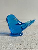 Right side profile of cobalt blue glass bird paperweight