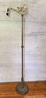 Full view of brass bridge floor lamp showing height and overall structure