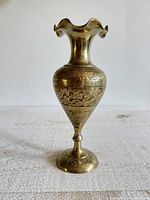 Full view of brass vase front showing etched patterns and shape