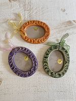 Front view of all three ceramic frames showing colors and design