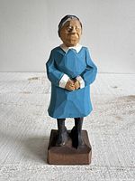 front three-quarter view of carved Granny figurine on base