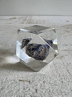 Overall view of lucite paperweight with blue stone inside