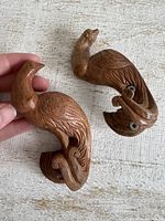 pair of carved wooden peacock wall hooks front view